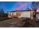 Charming brick home with a two-car garage, well-lit entrance, and inviting curb appeal at 8140 Pennsylvania Way, Denver, CO 80229