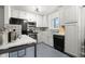Clean kitchen with white cabinets, black appliances, and colorful backsplash for a bright atmosphere at 8140 Pennsylvania Way, Denver, CO 80229
