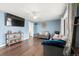 Inviting living room featuring a ceiling fan, hardwood floors, and large windows for ample natural light at 8140 Pennsylvania Way, Denver, CO 80229