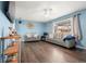 Bright living room with wood floors, large windows, ceiling fan, and neutral paint, creating a cozy space at 8140 Pennsylvania Way, Denver, CO 80229