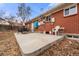 Patio area featuring a brick home, a small seating area, and a concrete foundation at 8140 Pennsylvania Way, Denver, CO 80229