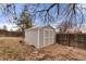 Backyard shed with wood siding and a fenced perimeter, providing extra storage space at 8140 Pennsylvania Way, Denver, CO 80229