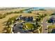An aerial view features the Southshore Lakehouse, lawns, lake, and winding neighborhood roads at 27653 E Euclid Dr, Aurora, CO 80016