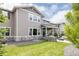 This home has a stone patio with covered seating, a built in fireplace, and a lush grassy yard at 27653 E Euclid Dr, Aurora, CO 80016