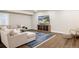 Finished basement featuring a comfortable sectional sofa, modern decor, and wood flooring at 27653 E Euclid Dr, Aurora, CO 80016