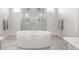 Luxurious bathroom features a freestanding soaking tub and a frameless glass shower enclosure at 27653 E Euclid Dr, Aurora, CO 80016
