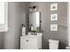 Stylish bathroom with a sleek vanity, modern fixtures, and framed photos on the wall at 27653 E Euclid Dr, Aurora, CO 80016
