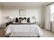 Serene bedroom features a tufted bench, neutral decor, and ample natural light at 27653 E Euclid Dr, Aurora, CO 80016