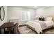 Cozy bedroom with a wood-frame bed, a modern desk, and large window providing plenty of natural light at 27653 E Euclid Dr, Aurora, CO 80016