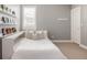 Cozy bedroom with built-in shelving, a comfortable bed, and a window with blinds at 27653 E Euclid Dr, Aurora, CO 80016