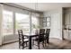 Elegant dining room with large windows, modern lighting, and a spacious dining table at 27653 E Euclid Dr, Aurora, CO 80016