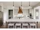 Modern kitchen featuring a large island with seating, pendant lighting, and stainless steel appliances at 27653 E Euclid Dr, Aurora, CO 80016