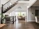 Open living space with a staircase, hardwood floors, and views to a backyard patio at 27653 E Euclid Dr, Aurora, CO 80016