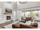 Bright living room boasting high ceilings, a fireplace, and sliding doors to the backyard at 27653 E Euclid Dr, Aurora, CO 80016