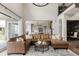 Spacious living area featuring a comfortable sectional sofa and an open layout to the kitchen at 27653 E Euclid Dr, Aurora, CO 80016