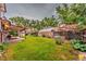 Large grassy backyard with a covered patio and a wooden fence for privacy at 1583 Skeel St, Brighton, CO 80601