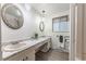 Bright bathroom featuring dual sinks with marble countertops and decorative mirrors at 1583 Skeel St, Brighton, CO 80601
