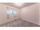 Simple bedroom with plush carpeting and a window providing natural light at 1583 Skeel St, Brighton, CO 80601
