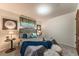Serene bedroom featuring a tufted gray bed, side tables with lamps, and soft, neutral decor for a restful retreat at 1583 Skeel St, Brighton, CO 80601