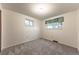 Neutral bedroom with carpet, two windows, and baseboard trim at 1583 Skeel St, Brighton, CO 80601