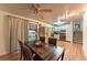 Inviting dining area with a wooden table, chairs, and a view of the kitchen; complemented by a sliding glass door at 1583 Skeel St, Brighton, CO 80601