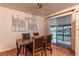 Cozy dining area with a wooden table, four chairs, and sliding glass doors leading to the outdoor area at 1583 Skeel St, Brighton, CO 80601