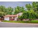 Charming two-story brick home with a well-maintained lawn, mature trees, and an attached garage at 1583 Skeel St, Brighton, CO 80601