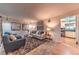 Cozy living room featuring comfortable seating, stylish decor, and an open doorway to the kitchen area at 1583 Skeel St, Brighton, CO 80601