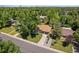Aerial view of a home with a well-manicured lawn, mature trees, and a driveway at 5525 E Bails Dr, Denver, CO 80222