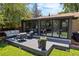 Enjoy outdoor living on this backyard deck with stylish seating and glass-enclosed sunroom at 5525 E Bails Dr, Denver, CO 80222