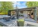 Relax in style on the backyard deck with seating, which transitions seamlessly into a glass-enclosed sunroom at 5525 E Bails Dr, Denver, CO 80222