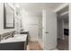 Modern bathroom featuring double vanities, updated fixtures, and a glass enclosed shower at 5525 E Bails Dr, Denver, CO 80222