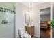 Bathroom featuring a modern shower, vanity, and views of the bedroom at 5525 E Bails Dr, Denver, CO 80222