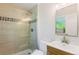 Bathroom featuring tiled walk-in shower, modern fixtures, and a vanity at 5525 E Bails Dr, Denver, CO 80222