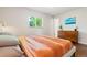 Bedroom showcasing window with view, dresser, and comfortable bedding at 5525 E Bails Dr, Denver, CO 80222