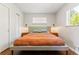 Cozy bedroom with hardwood floors, a neutral color palette, modern sconces, and ample natural light at 5525 E Bails Dr, Denver, CO 80222