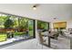 Dining room with large sliding glass doors to the backyard, natural light, modern table, and seating at 5525 E Bails Dr, Denver, CO 80222