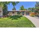 Charming brick ranch-style home with lush green lawn and meticulously landscaped front yard at 5525 E Bails Dr, Denver, CO 80222