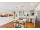 Modern kitchen features grey cabinetry, center island with seating, and stainless steel appliances at 5525 E Bails Dr, Denver, CO 80222