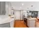 Stylish kitchen with stainless steel appliances, gray cabinets, modern hardware, tile backsplash, and hardwood floors at 5525 E Bails Dr, Denver, CO 80222