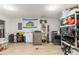 Spacious laundry room featuring modern washer and dryer, utility sink and ample storage shelves at 5525 E Bails Dr, Denver, CO 80222