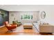 Well-lit living room showcasing a mix of contemporary furniture, hardwood floors, and large bay window at 5525 E Bails Dr, Denver, CO 80222