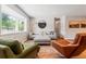 Bright and airy living room with large windows, hardwood floors, and comfortable seating arrangement at 5525 E Bails Dr, Denver, CO 80222