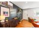 Stylish living room featuring dark accent wall, hardwood floors, and modern decor at 5525 E Bails Dr, Denver, CO 80222