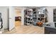 Basement storage area with shelving adjacent to finished living space at 5525 E Bails Dr, Denver, CO 80222