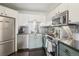 Modern kitchen with stainless steel appliances and granite countertops at 550 E 12Th Ave # 509, Denver, CO 80203