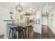 Open concept kitchen and dining area with breakfast bar and dark wood floors at 550 E 12Th Ave # 509, Denver, CO 80203