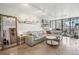 Living room with L-shaped sofa, coffee table, and city views at 550 E 12Th Ave # 509, Denver, CO 80203