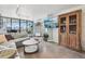 Living room with L-shaped sofa, coffee table, and large TV at 550 E 12Th Ave # 509, Denver, CO 80203