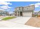 Attractive two-story home featuring a two-car garage, nice lawn, and appealing exterior color scheme at 2206 Crosswind St, Fort Lupton, CO 80621